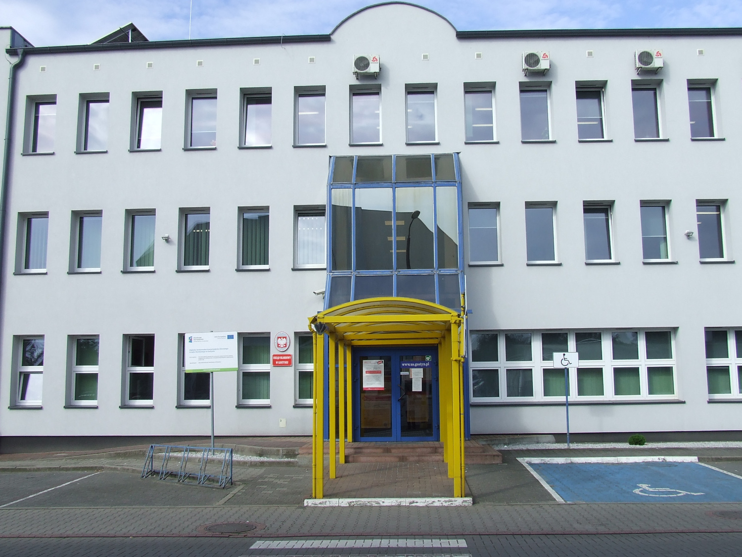 Na zdjęciu budynek w jasno - niebieskiej elewacji