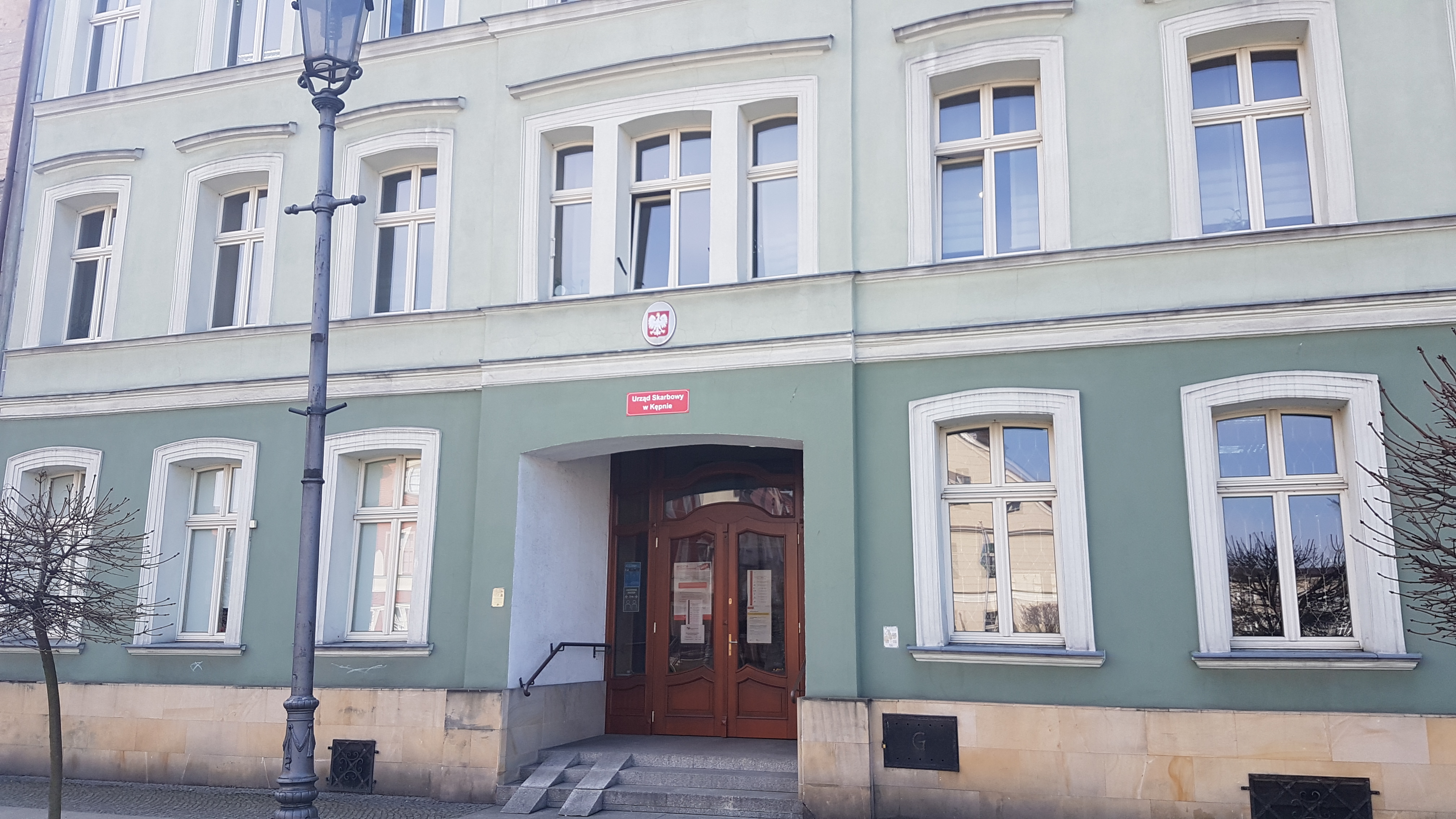 Na zdjęciu budynek w jasno-szarej elewacji 