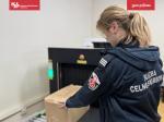 Funkcjonariuszka Służby Celno-Skarbowej sprawdza przesyłkę pocztową na urządzeniu RTG